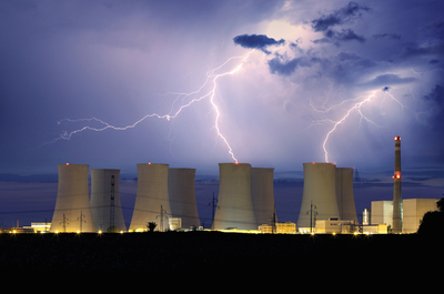 Power plant with lightning in the background