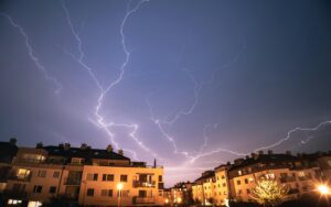 Captivating night scene with lightning over residential buildings in Gdynia, Poland.